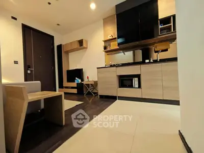 Modern living room with sleek furniture and built-in storage solutions.