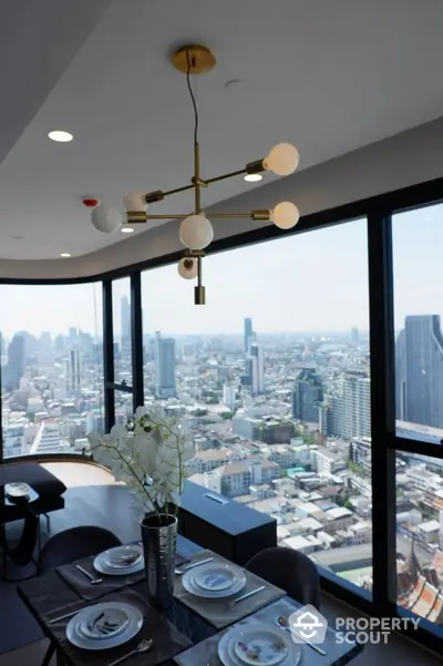 Luxurious dining area with panoramic city view and modern chandelier