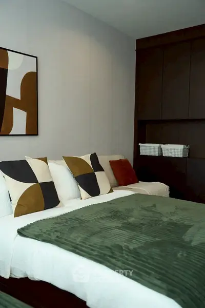 Modern bedroom with stylish decor and cozy bedding