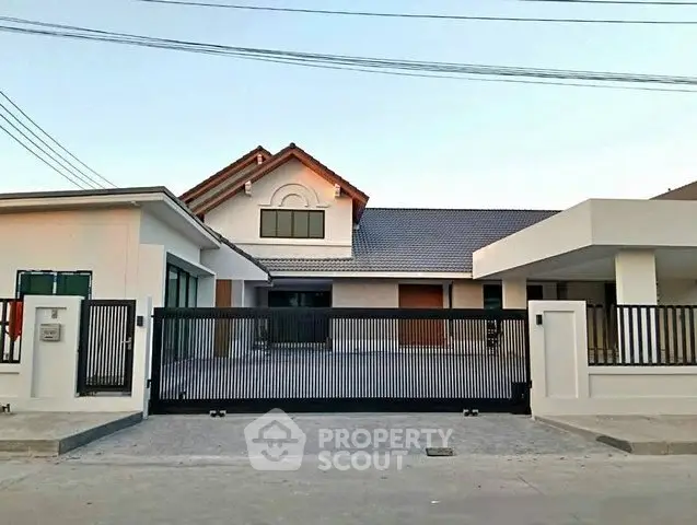 Modern single-story house with gated entrance and spacious driveway