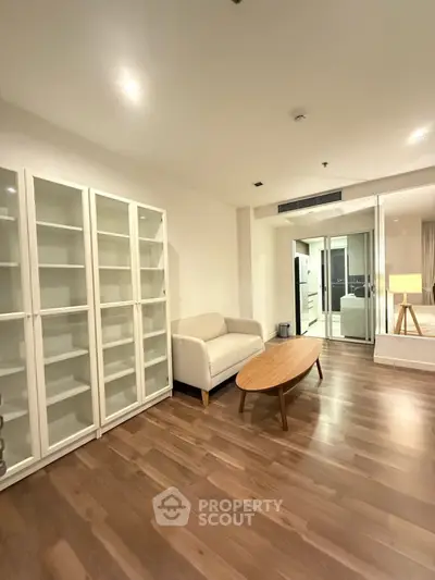 Spacious living room with modern furniture and wooden flooring