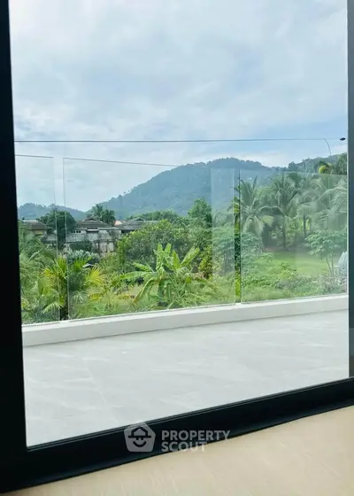 Stunning balcony view with lush greenery and mountain backdrop, perfect for relaxation and nature lovers.
