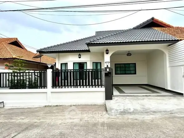 Charming single-story house with tiled roof and spacious driveway in a serene neighborhood.