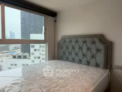 Modern bedroom with stylish headboard and city view from window