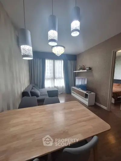 Modern living room with stylish lighting and cozy furniture in a contemporary apartment.