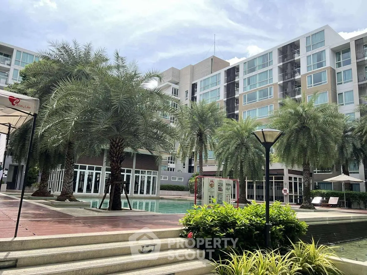 Luxurious residential complex with pool and palm trees, modern architecture
