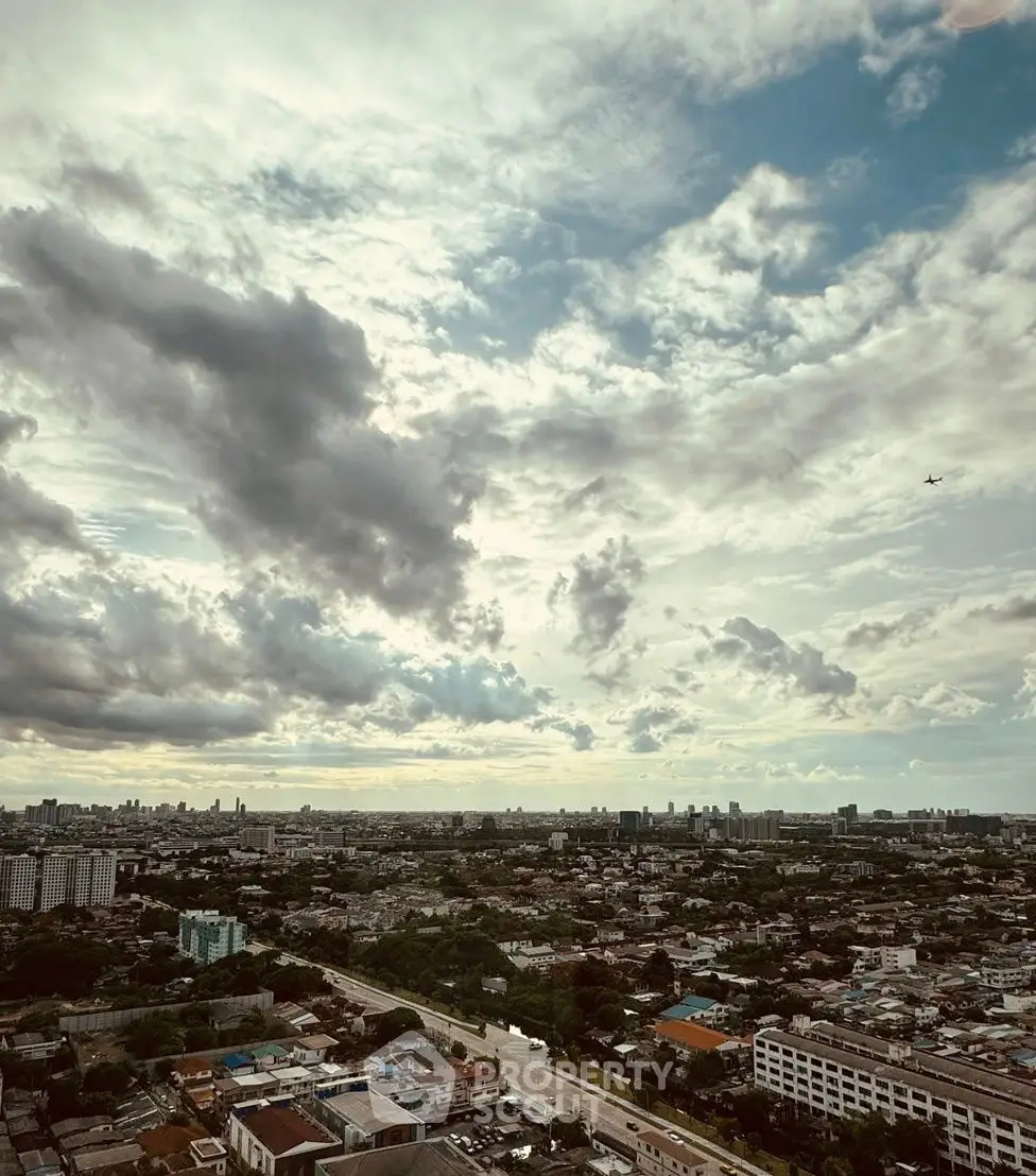 Stunning aerial cityscape view with expansive skyline and dramatic clouds, perfect for urban living enthusiasts.