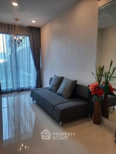 Modern living room with sleek gray sofa and elegant decor