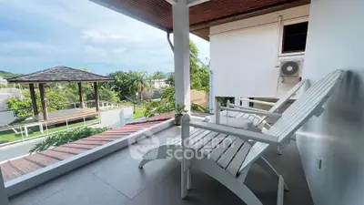 Charming balcony with scenic view and cozy seating in tropical setting