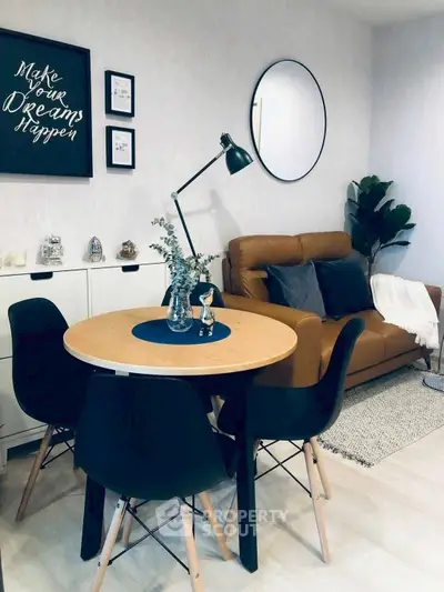 Stylish living room with modern decor, round table, and cozy seating area.