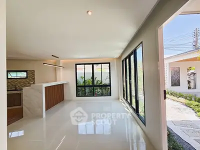 Spacious modern living room with large windows and garden view, perfect for natural light lovers.