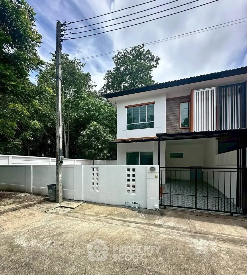 Charming two-story house with modern design and spacious driveway in a serene neighborhood.