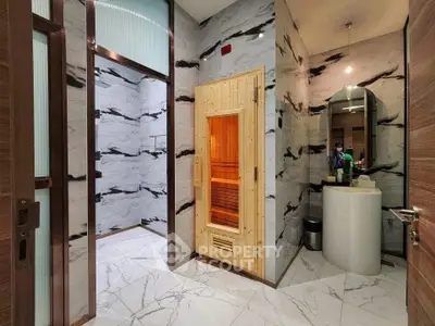 Luxurious spa-like bathroom with sauna and elegant marble finishes