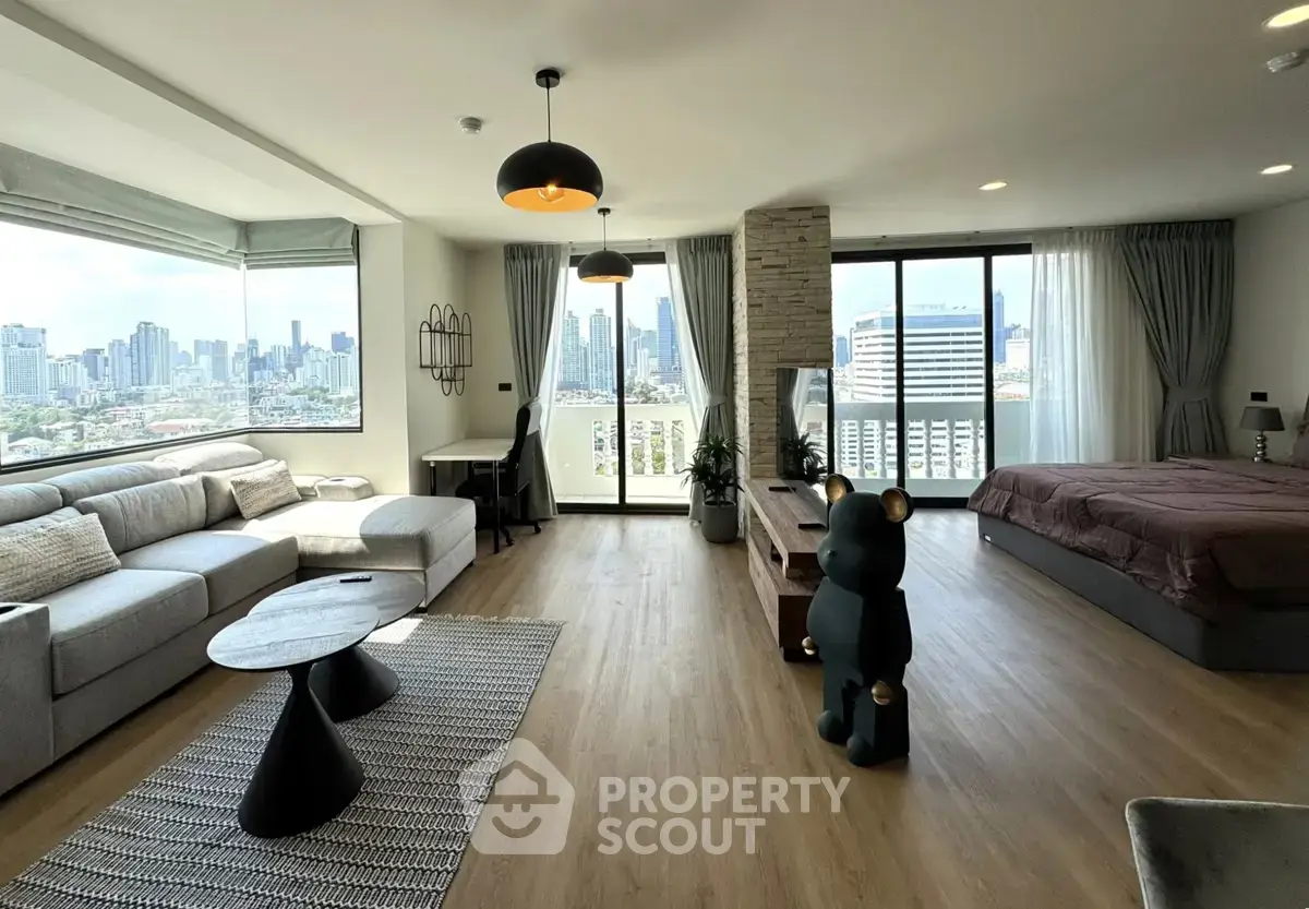 Spacious modern living room with city view, open layout, and stylish decor