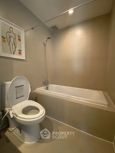 Modern bathroom with bathtub and stylish wall art in a sleek design.