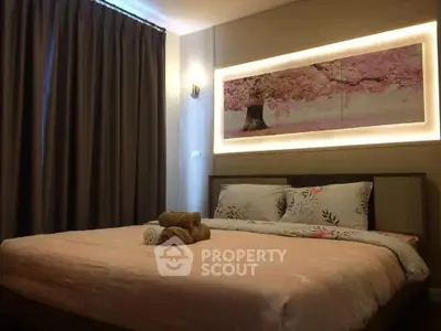 Cozy bedroom with elegant decor and soft lighting, featuring a large bed and stylish wall art.