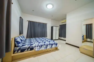 Spacious bedroom with modern decor and ample natural light