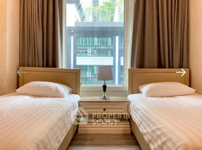 Charming bedroom with twin beds and city view, perfect for urban living.