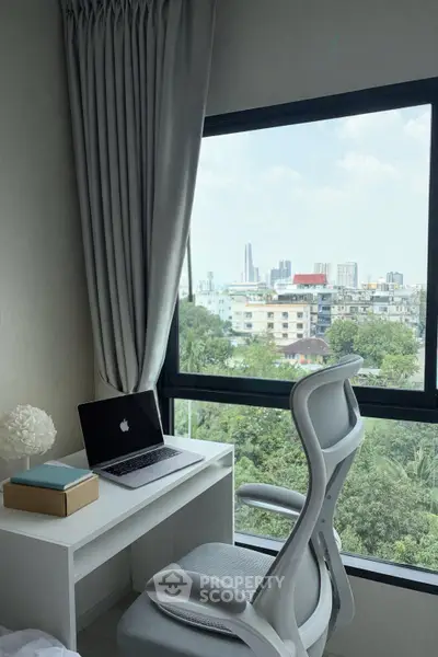 Modern study area with city view, featuring sleek desk and ergonomic chair by large window.