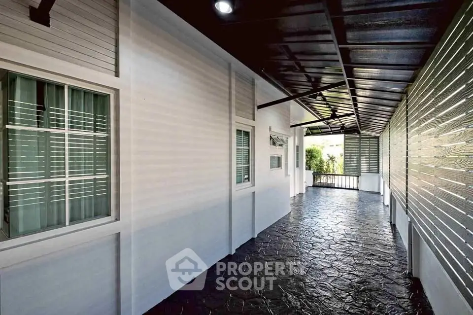 Spacious covered walkway with modern design and natural light