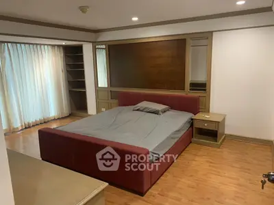 Spacious bedroom with modern design and ample natural light