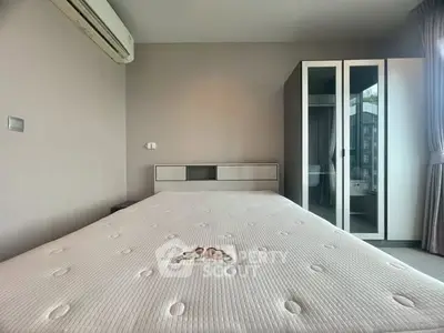Spacious bedroom with modern wardrobe and air conditioning unit