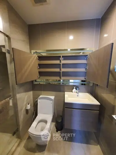 Modern bathroom with sleek fixtures and ample storage space in a contemporary apartment.