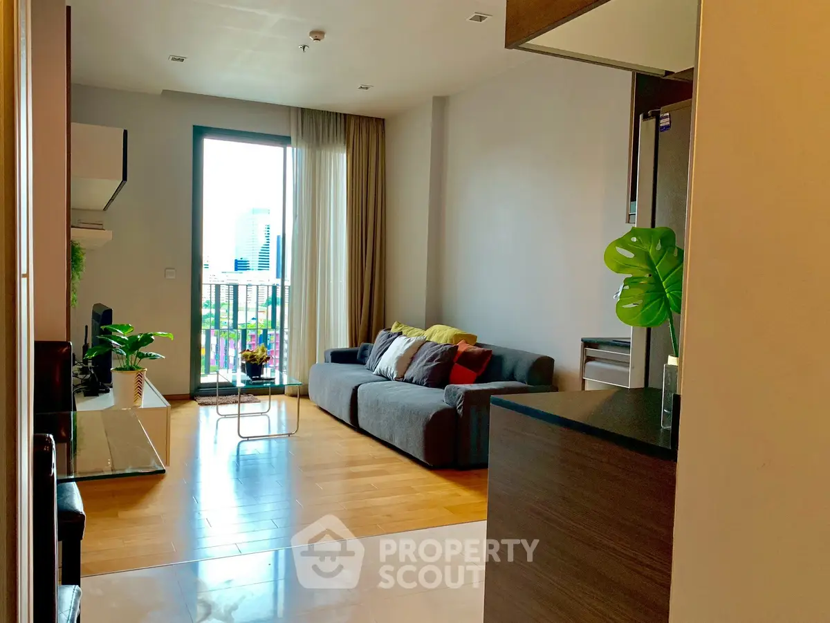 Modern living room with city view, cozy sofa, and stylish decor