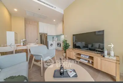 Modern living room with stylish furniture and open kitchen layout