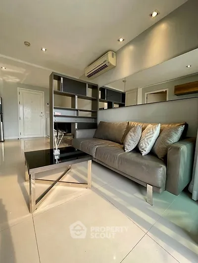 Modern living room with sleek furniture and air conditioning in a stylish apartment.