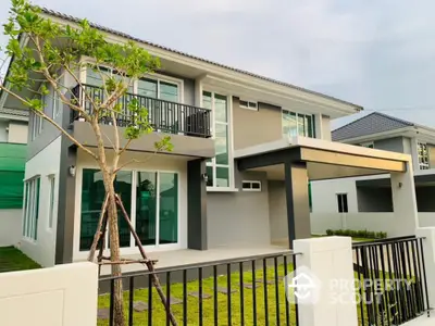 Modern two-story house with sleek design and spacious balcony in a serene neighborhood.