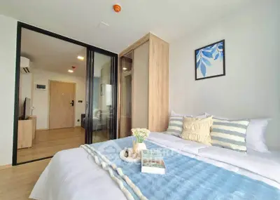 Modern bedroom with stylish decor and glass partition in a contemporary apartment.