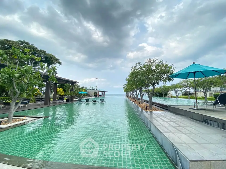 Luxurious infinity pool with ocean view and lush greenery, perfect for relaxation and leisure.