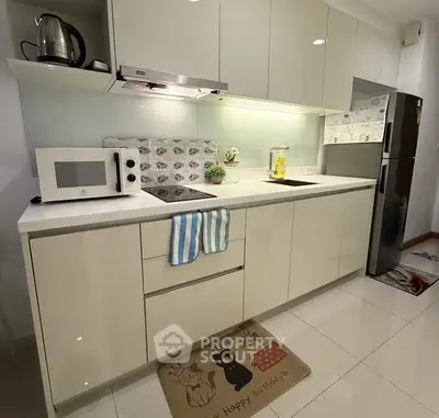 Modern kitchen with sleek cabinets and appliances, perfect for culinary enthusiasts.