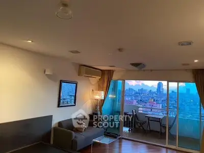 Spacious living room with city view and balcony access in modern apartment.
