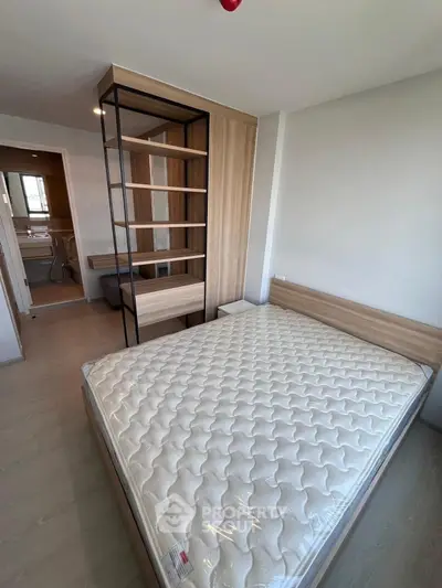 Modern bedroom with stylish wooden furniture and comfortable mattress