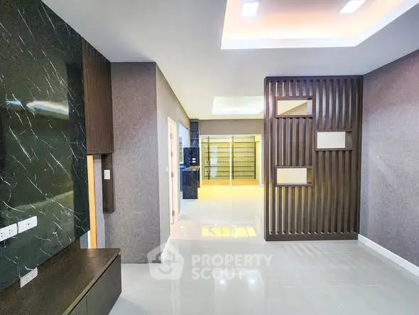 Modern interior with sleek design and open layout, featuring elegant wall accents and recessed lighting.