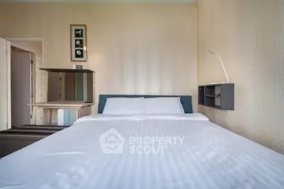 Cozy bedroom with modern decor and comfortable bed in a stylish apartment.