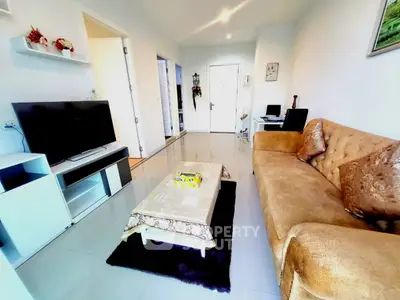 Modern living room with cozy sofa and sleek TV setup, perfect for relaxation and entertainment.