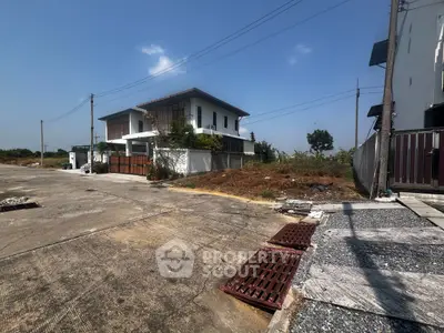 Modern two-story house with spacious driveway and clear blue sky, ideal for suburban living.