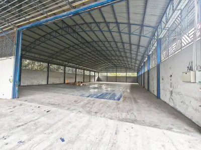 Spacious industrial warehouse with high ceilings and ample storage space.