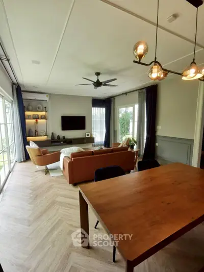 Spacious living room with modern decor and large windows for natural light