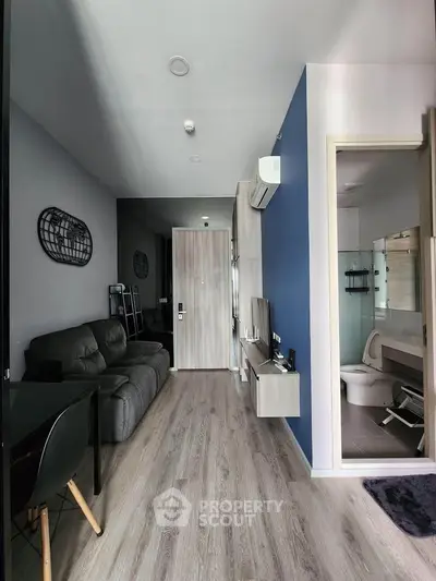 Modern apartment interior with sleek living room and bathroom, featuring stylish decor and contemporary design.