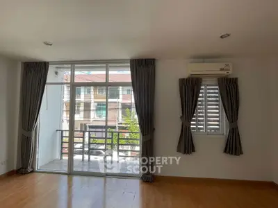 Spacious living room with large windows and balcony access