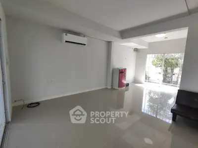 Spacious modern living room with air conditioning and glossy tiled floors