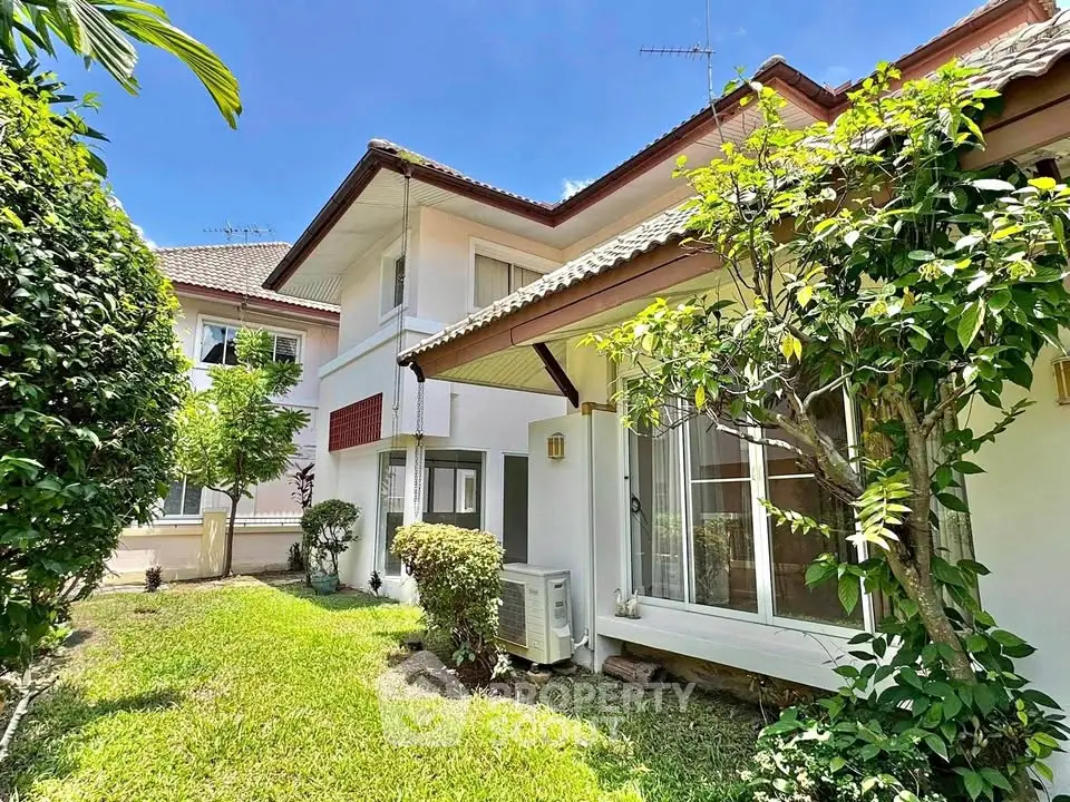 Charming suburban house with lush garden and sunny exterior view.