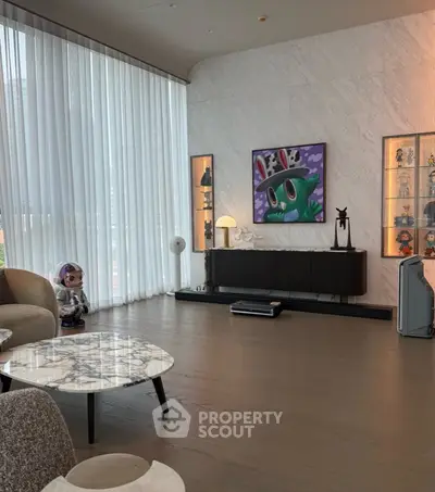 Luxurious modern living room with high ceilings, marble table, and stylish decor.