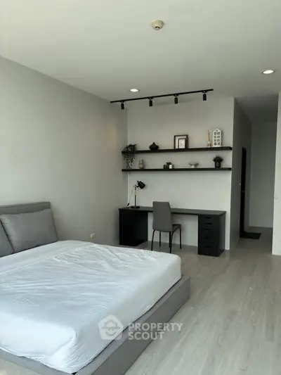 Modern bedroom with sleek desk and minimalist decor