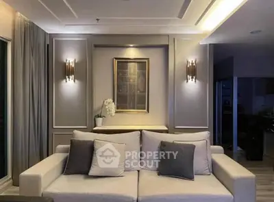 Elegant living room with modern lighting and cozy sofa in a stylish apartment.