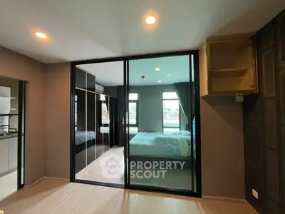 Modern bedroom with glass sliding doors and city view